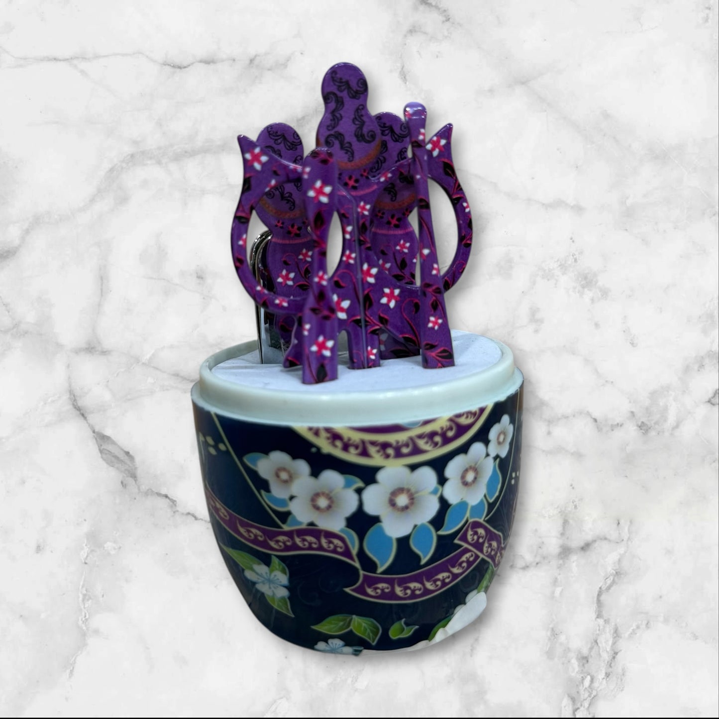 Russian Matryoshka nesting doll manicure set with a -piece stainless steel nail care kit inside a decorative travel case.