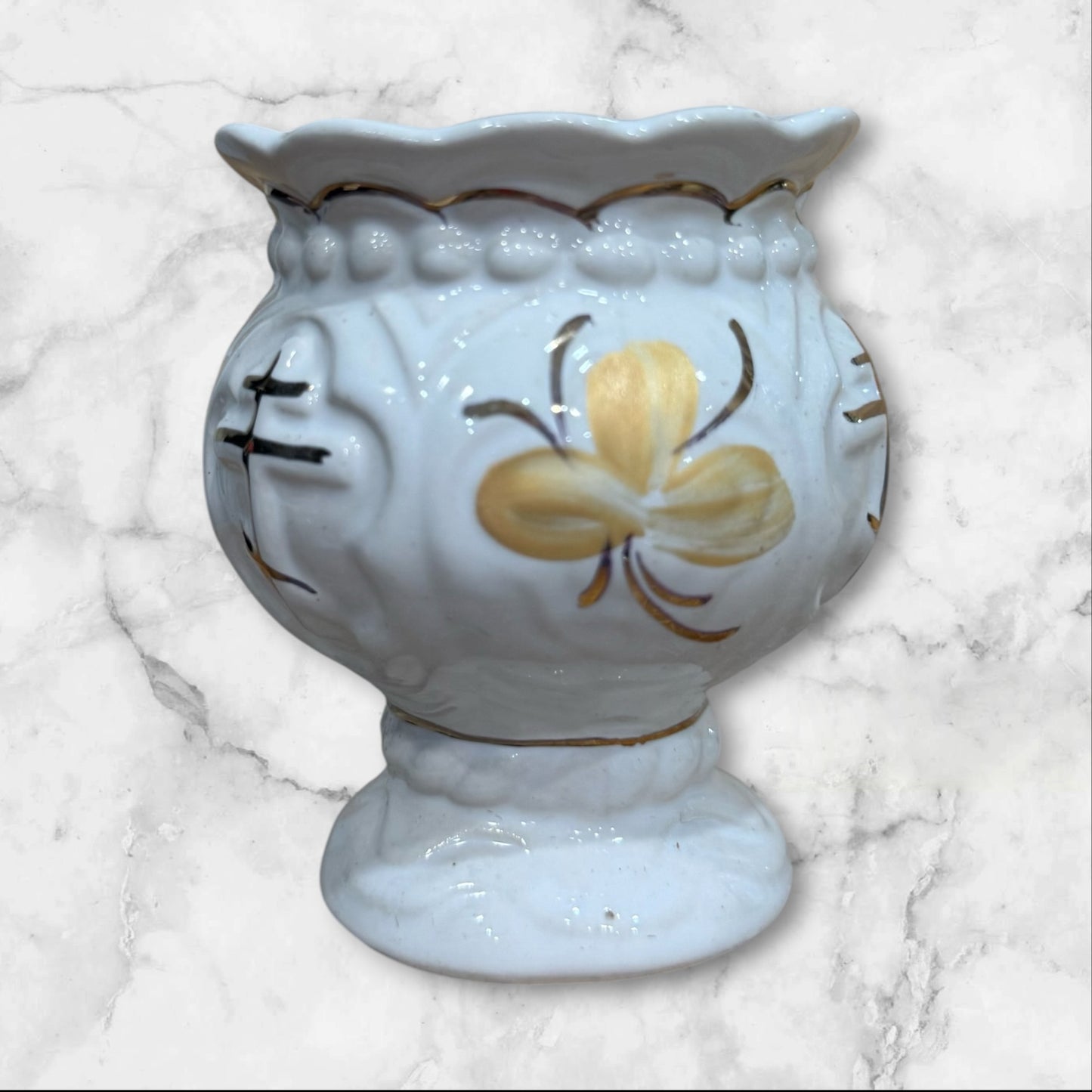 White ceramic Orthodox holy water cup with gold cross and floral decoration on a pedestal base