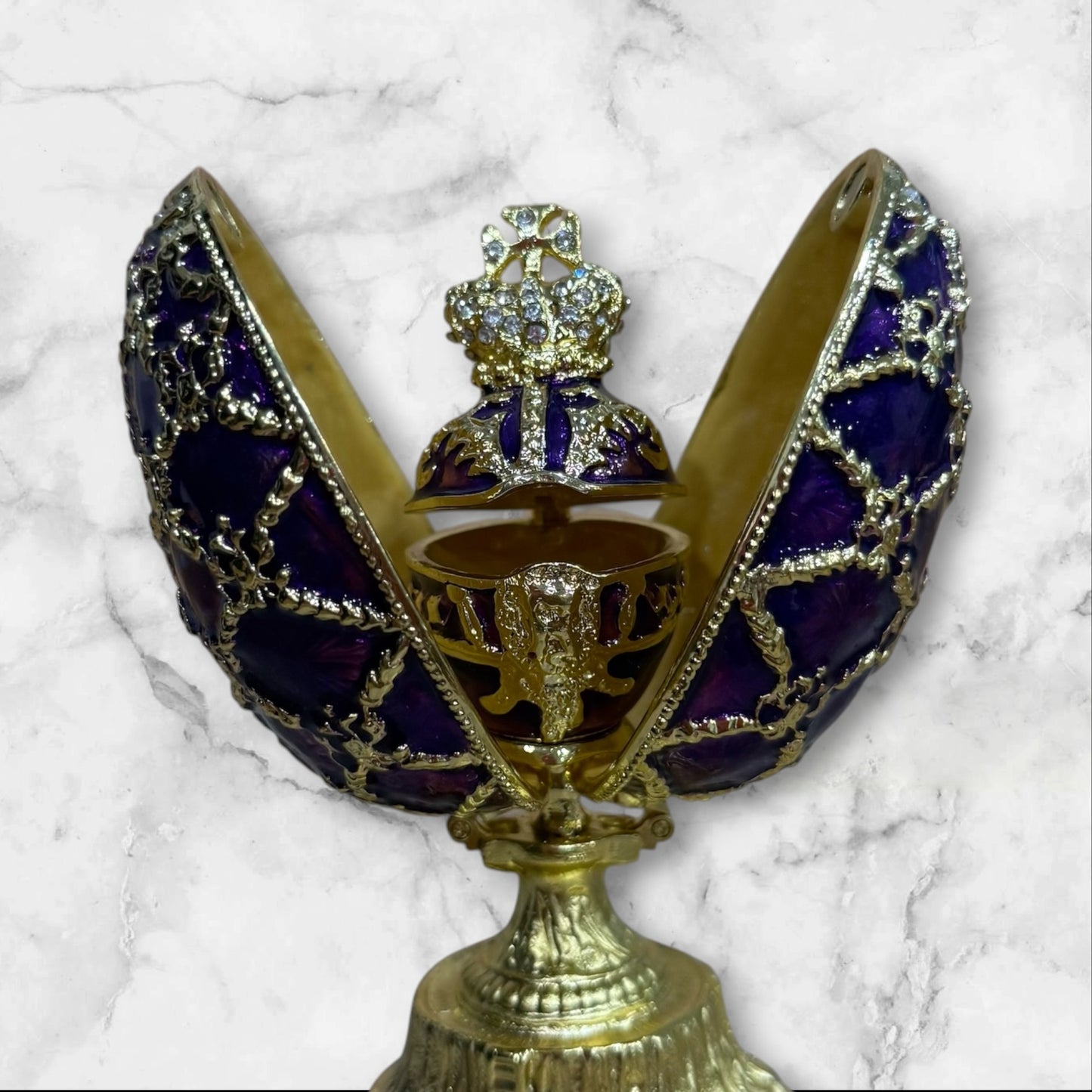 Purple Imperial Fabergé-style egg jewelry box opened to reveal hidden compartment