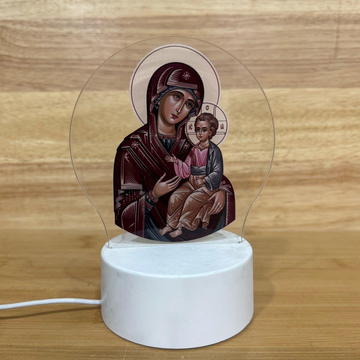Illuminated acrylic LED night light featuring the Mother of God of Kazan icon on a white USB-powered base. Ideal for an icon corner, bedside table, nursery, or prayer space.