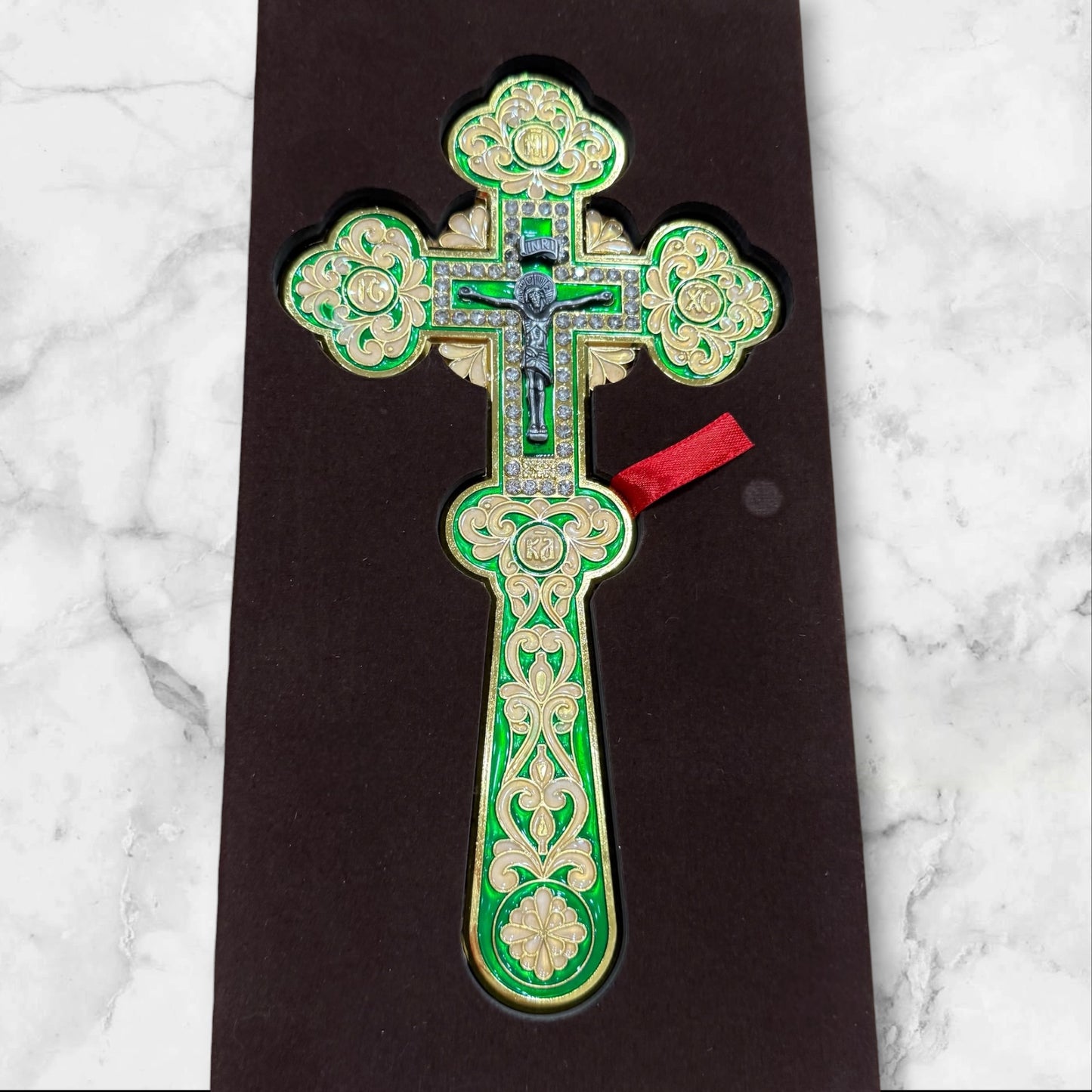 Green enamel blessing cross with decorative metal crucifix in a premium gift box, measuring 7.875 inches tall.