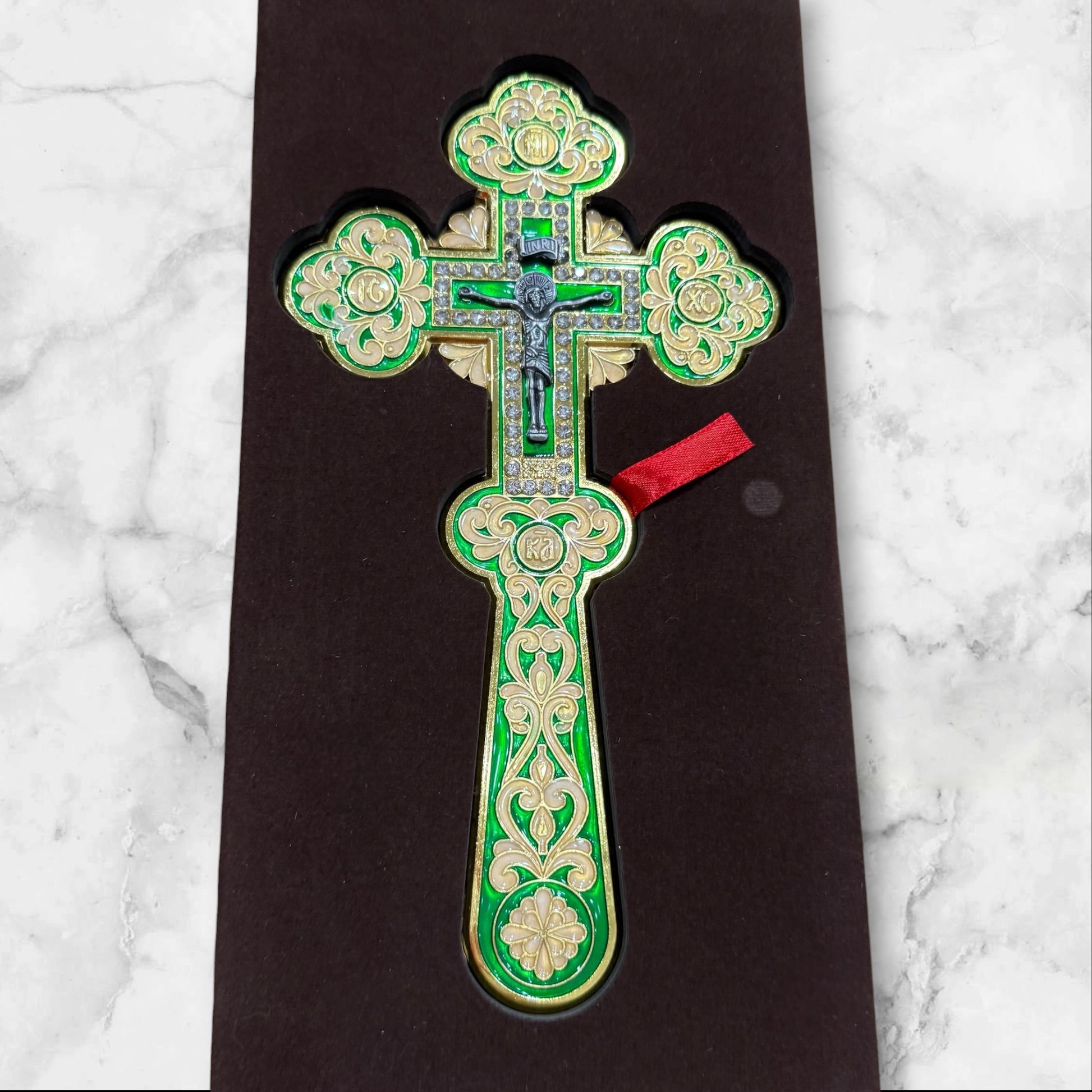 Green enamel blessing cross with decorative metal crucifix in a premium gift box, measuring 7.875 inches tall.