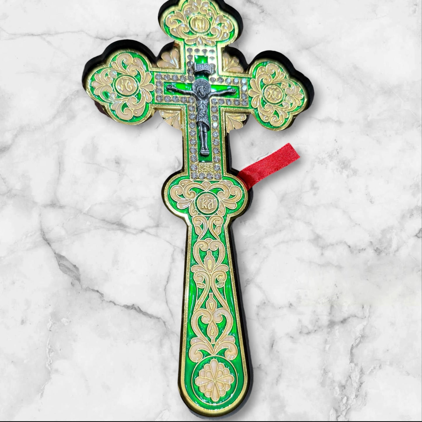 Green enamel blessing cross with decorative metal crucifix in a premium gift box, measuring 7.875 inches tall.