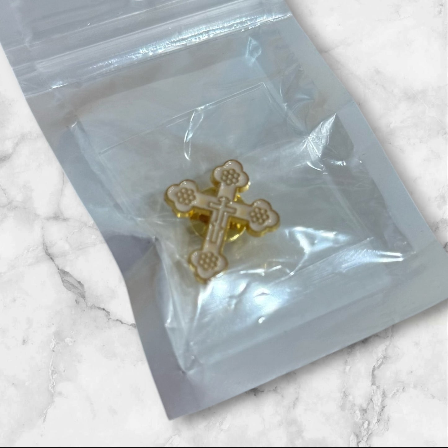 White and gold Orthodox cross lapel pin with enamel finish and secure metal backing, measuring 1 inch tall.