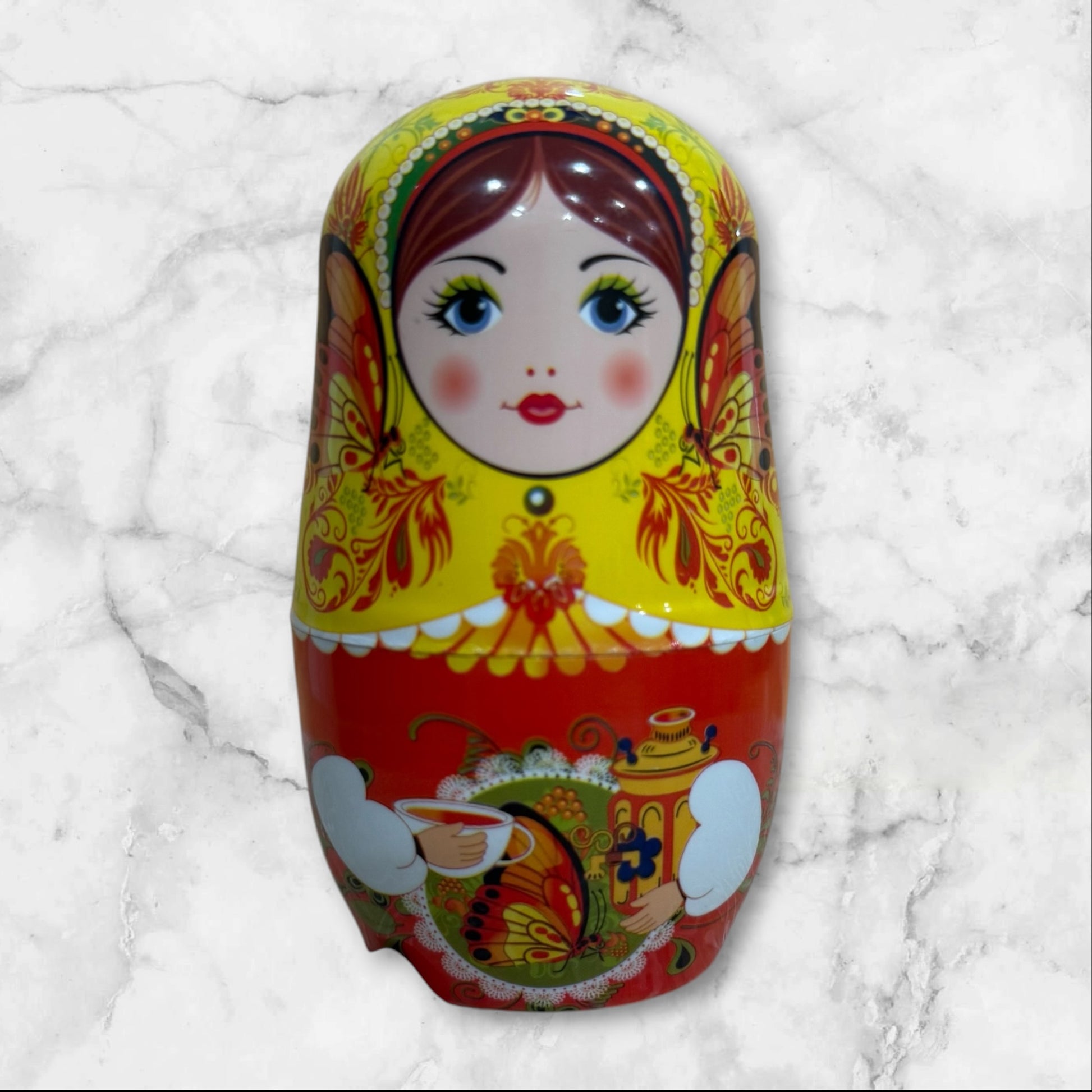 Yellow Russian Matryoshka nesting doll manicure set with a six-piece stainless steel nail care kit inside a decorative travel case.