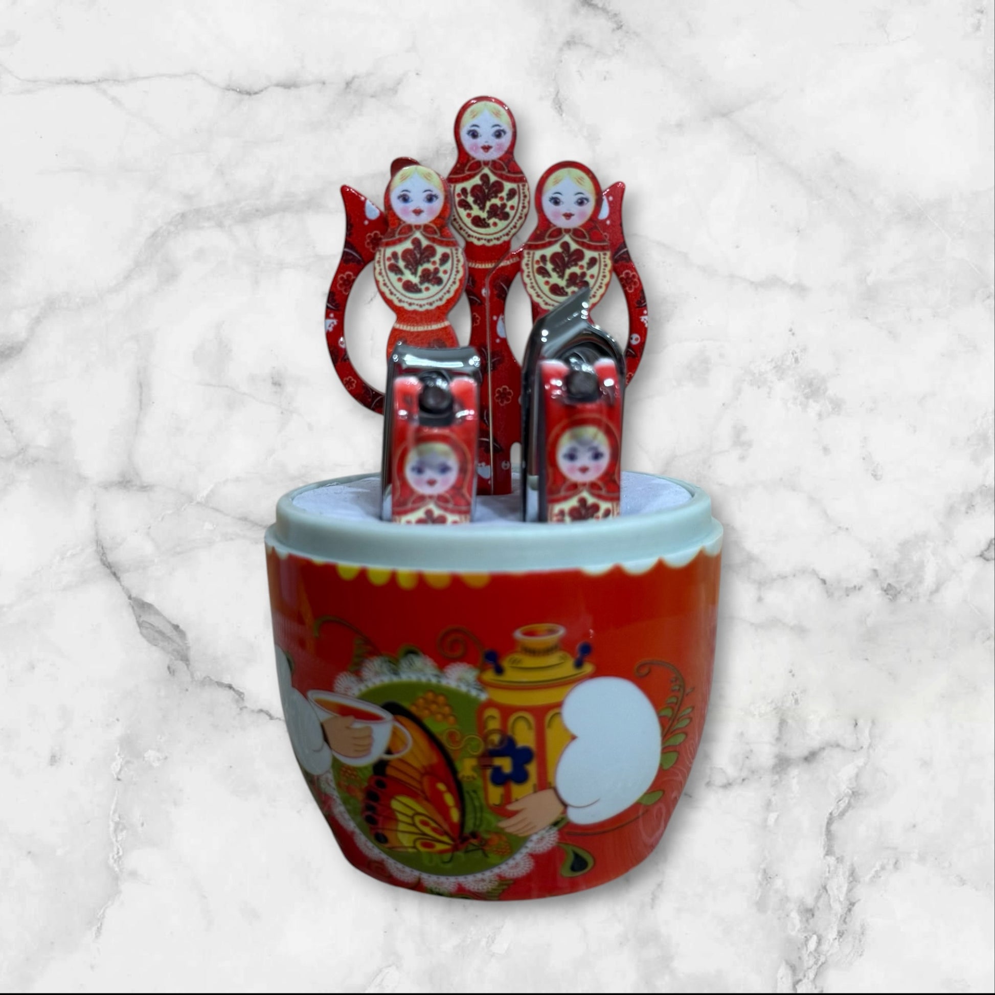 Yellow Russian Matryoshka nesting doll manicure set with a six-piece stainless steel nail care kit inside a decorative travel case.