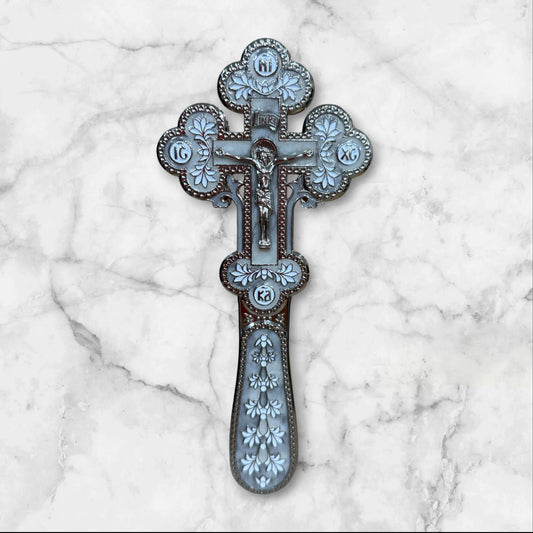 white enamel blessing cross with metal crucifix displayed inside a premium gift box.