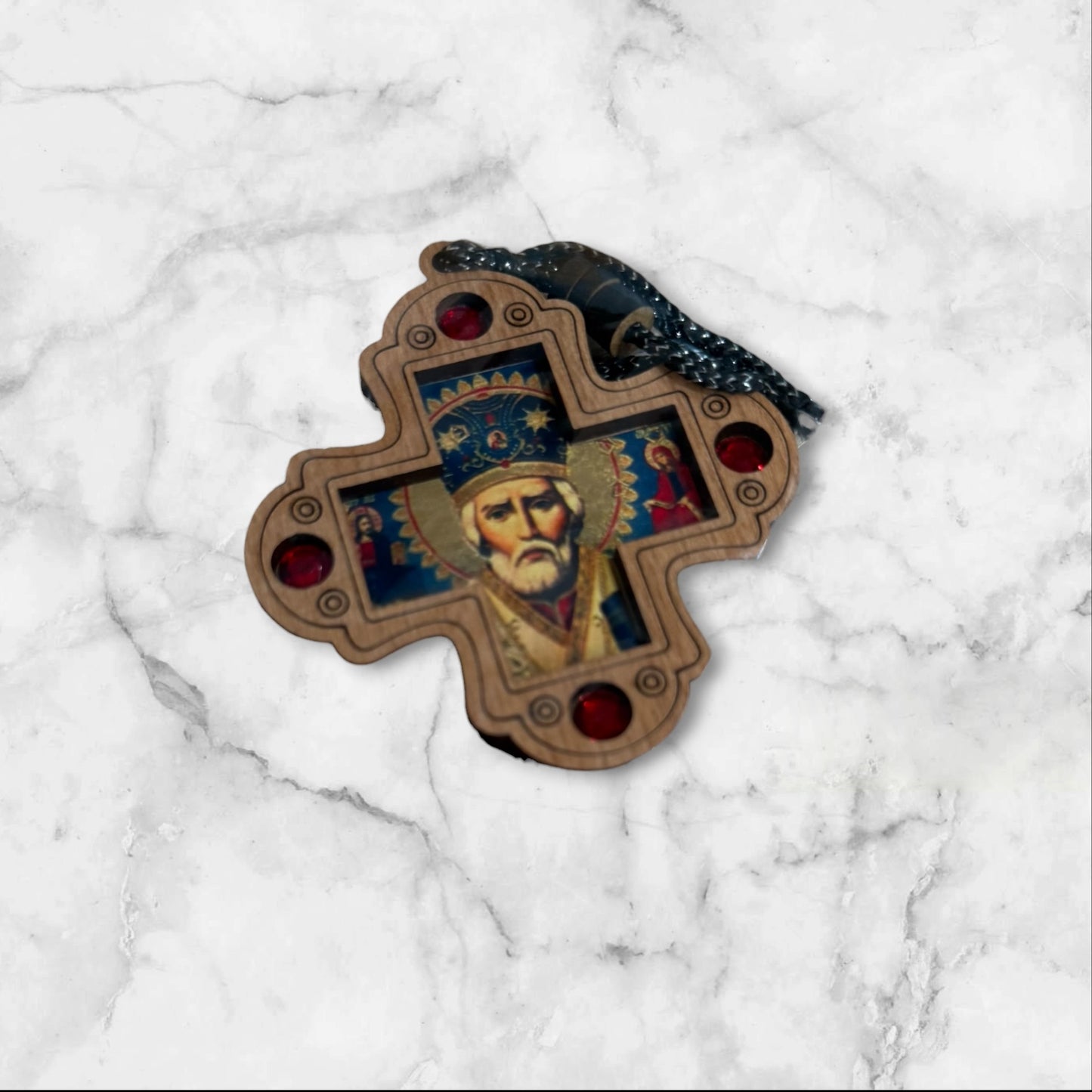 Wood hanging icon of Saint Nicholas with decorative red jewel accents and hanging cord, measuring 2.75 inches tall.