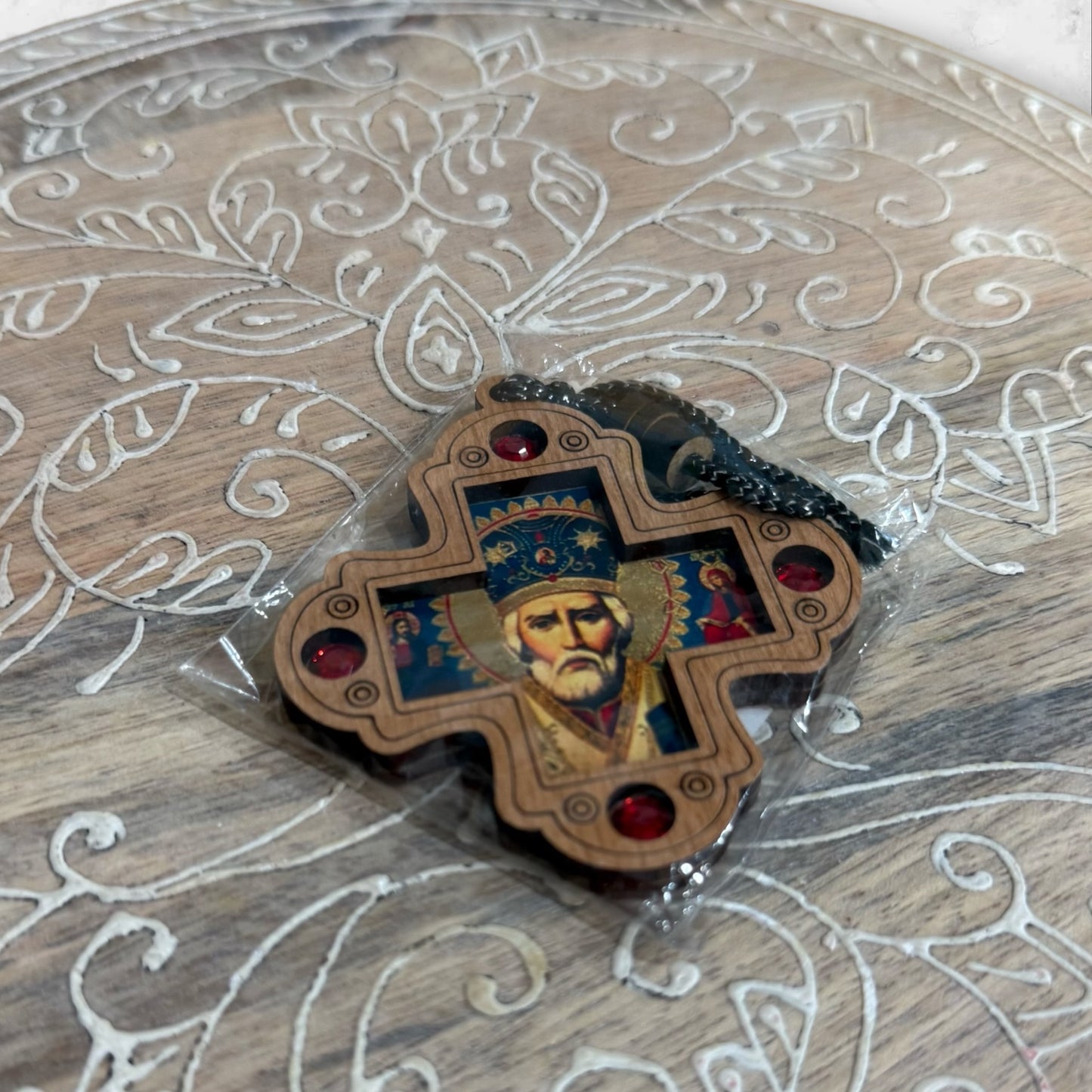 Wood hanging icon of Saint Nicholas with decorative red jewel accents and hanging cord, measuring 2.75 inches tall.