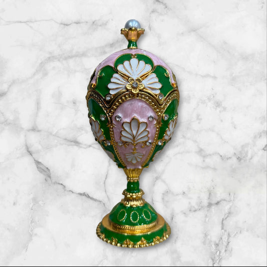 Green and pink Fabergé-style enamel jewelry box on decorative pedestal