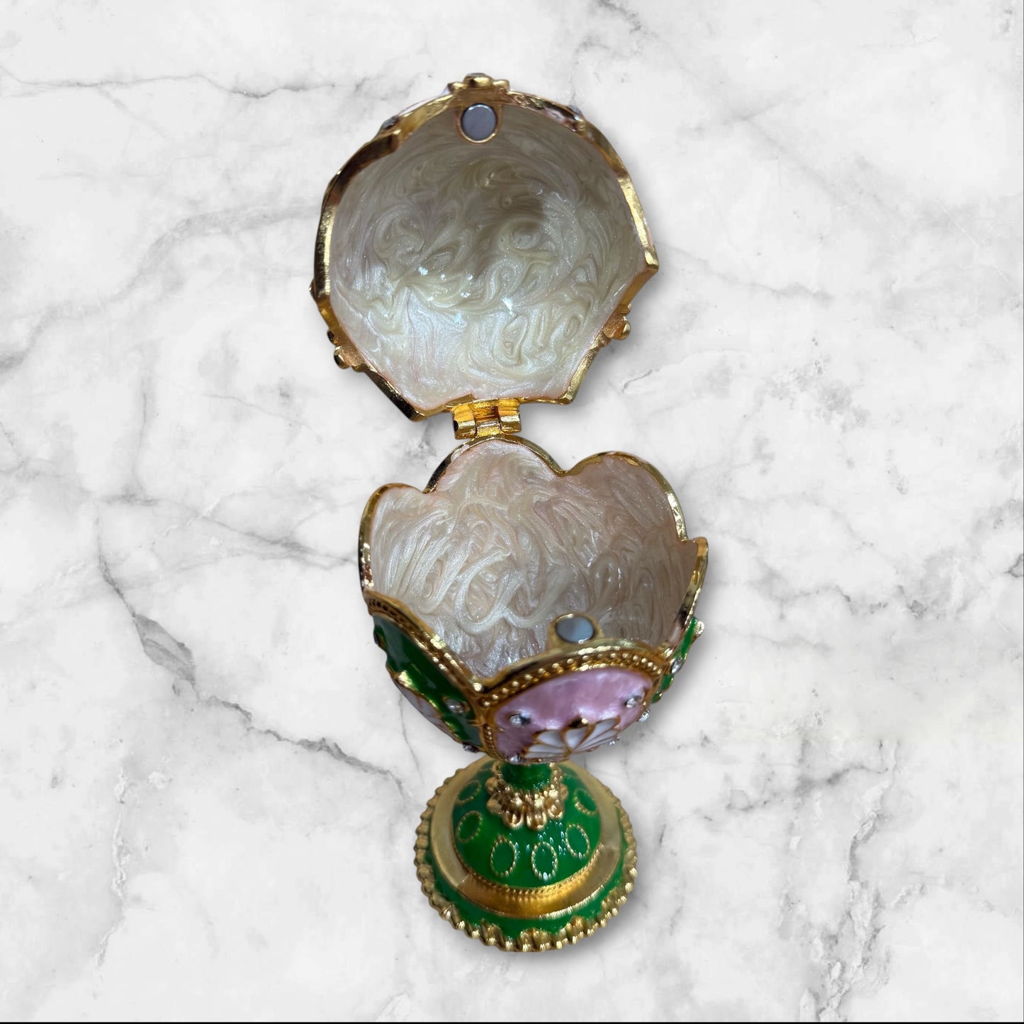 Open Fabergé-style jewelry box showing interior storage compartment