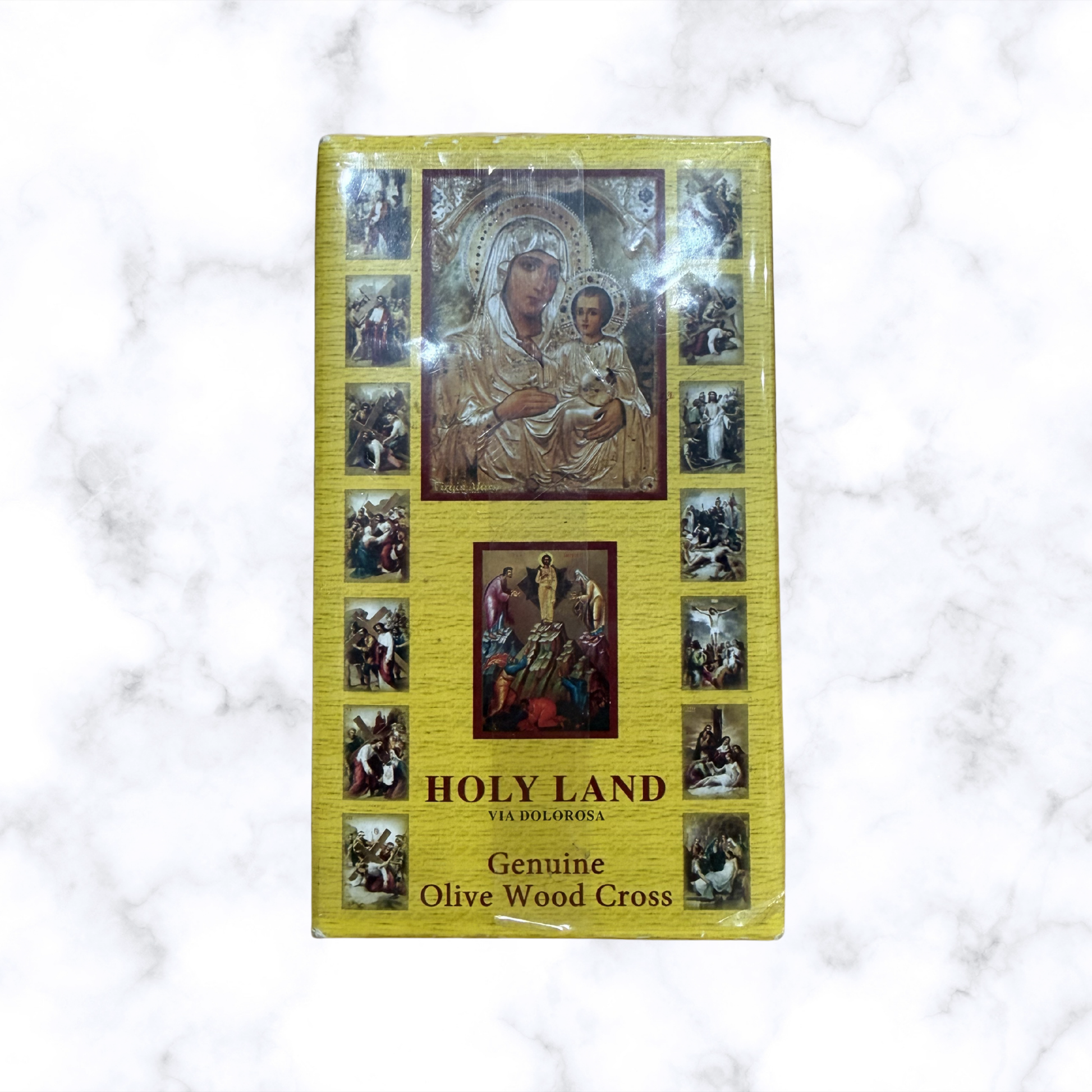 Front of Holy Land blessing gift set featuring a genuine olive wood cross and traditional Christian artwork on the gift box.
