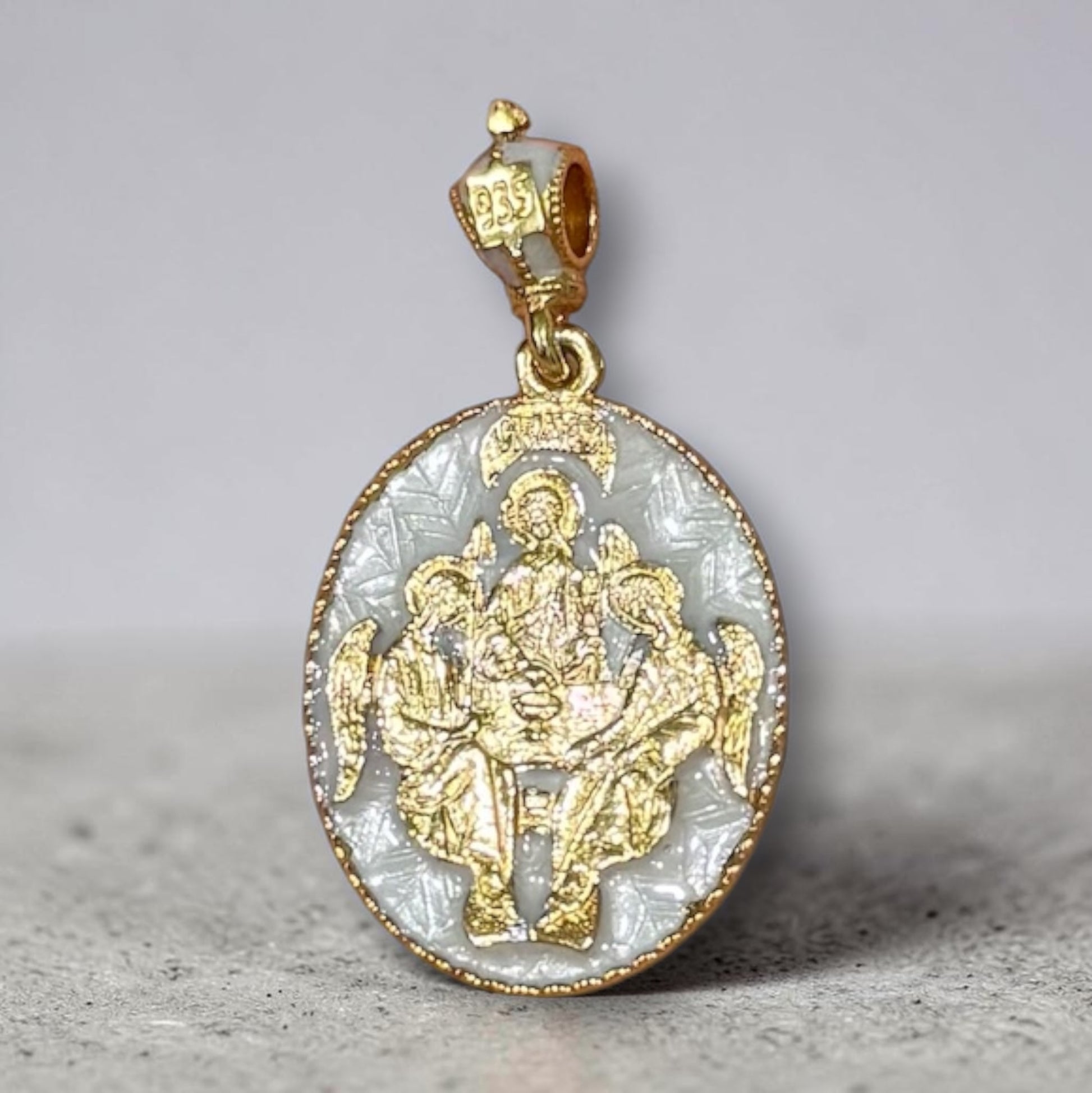 Gold-tone and white enamel Mother of God Hospitality of Abraham Orthodox icon pendant.