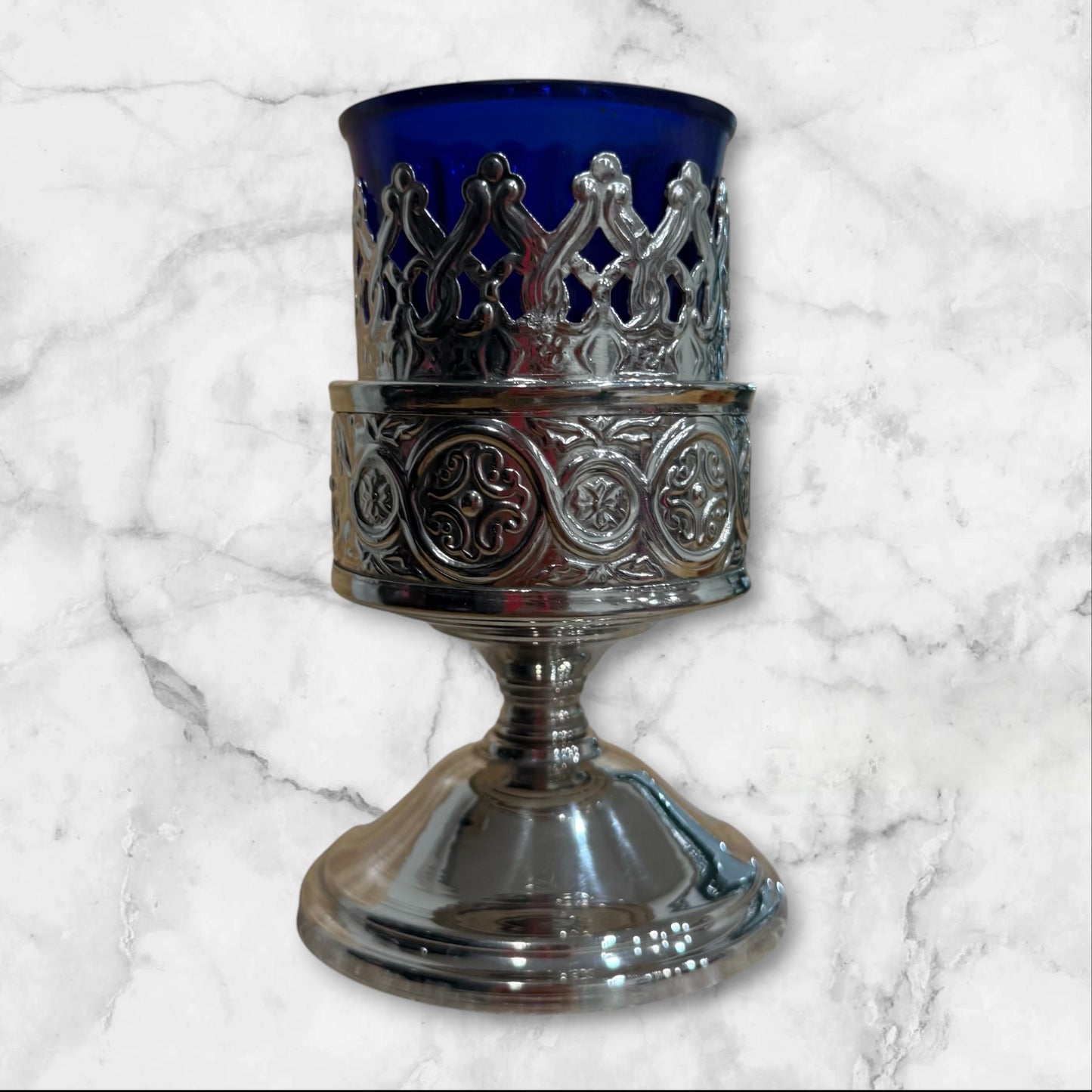 Orthodox blue glass votive lamp with ornate silver-tone holder for a home prayer corner