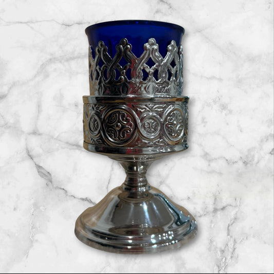 Orthodox blue glass votive lamp with ornate silver-tone holder for a home prayer corner