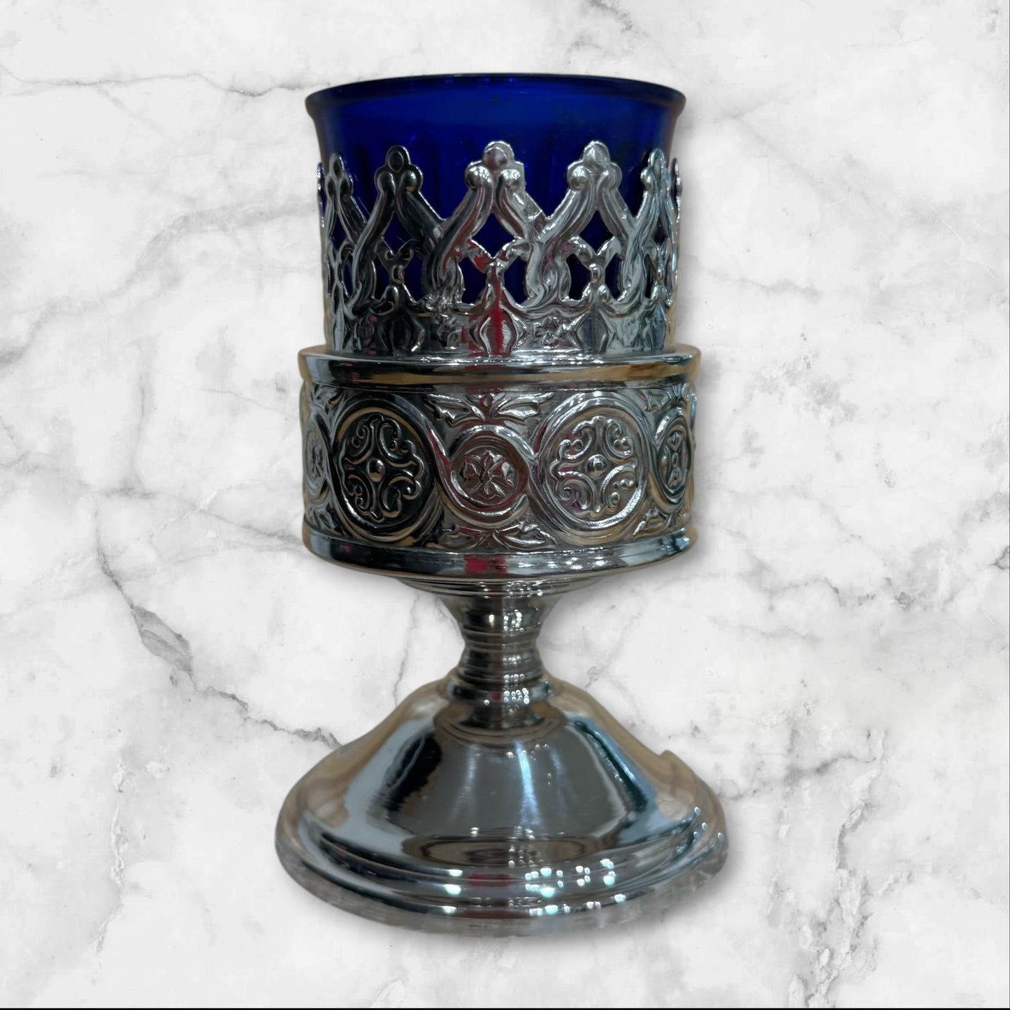 Orthodox blue glass votive lamp with ornate silver-tone holder for a home prayer corner