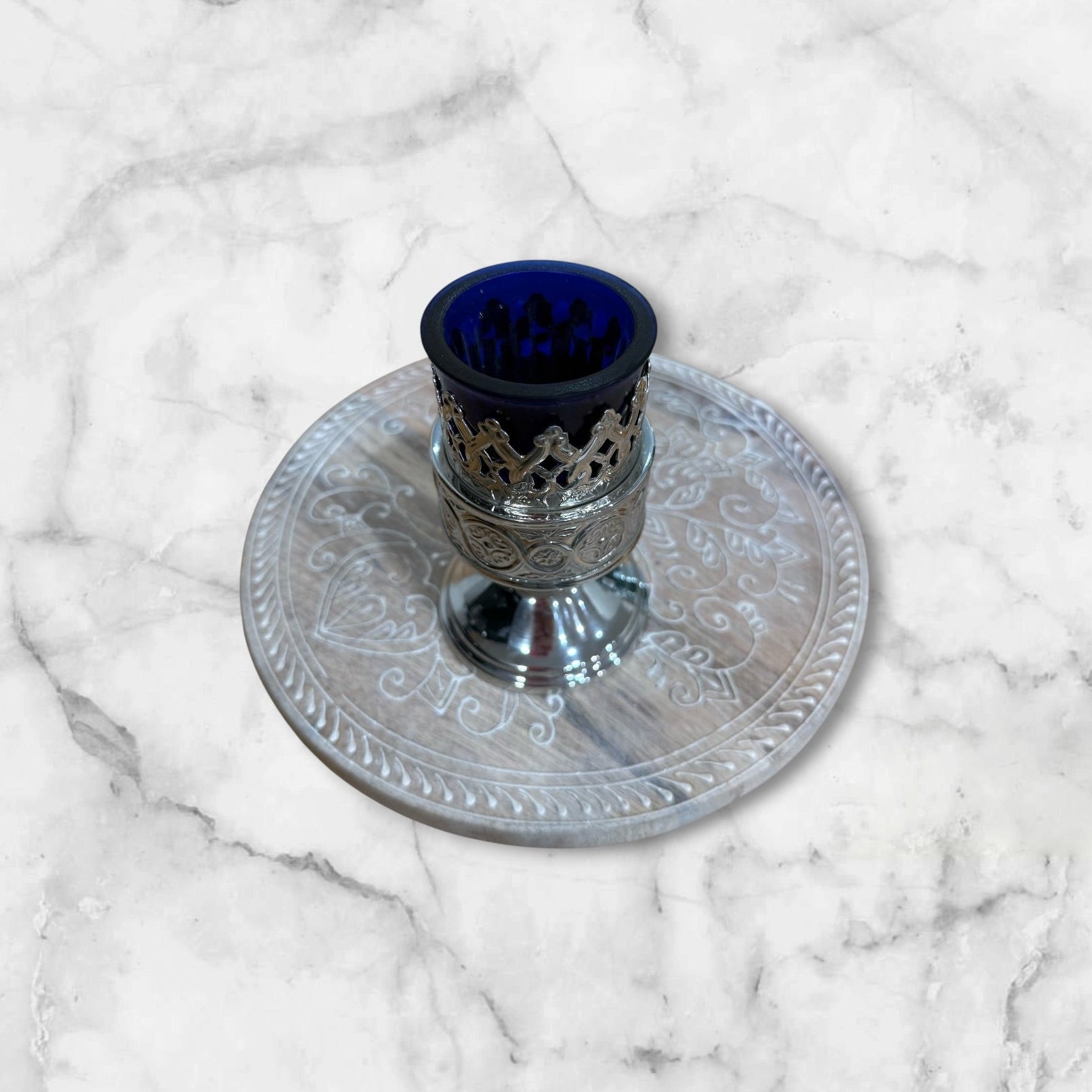 Orthodox blue glass votive lamp with ornate silver-tone holder for a home prayer corner