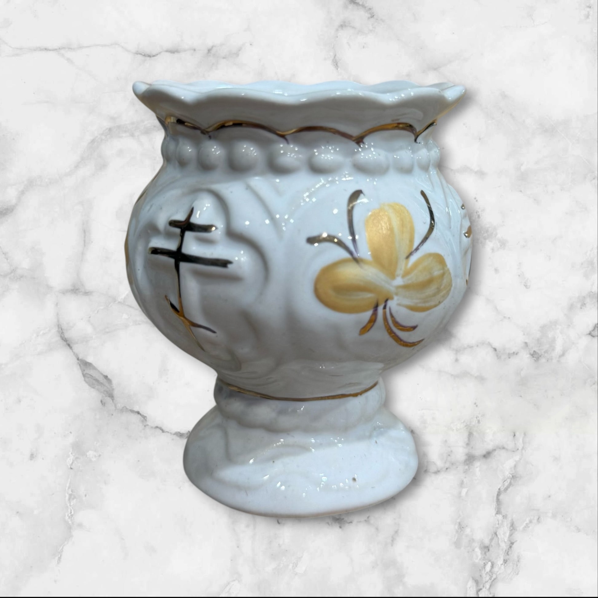 White ceramic Orthodox holy water cup with gold cross and floral decoration on a pedestal base