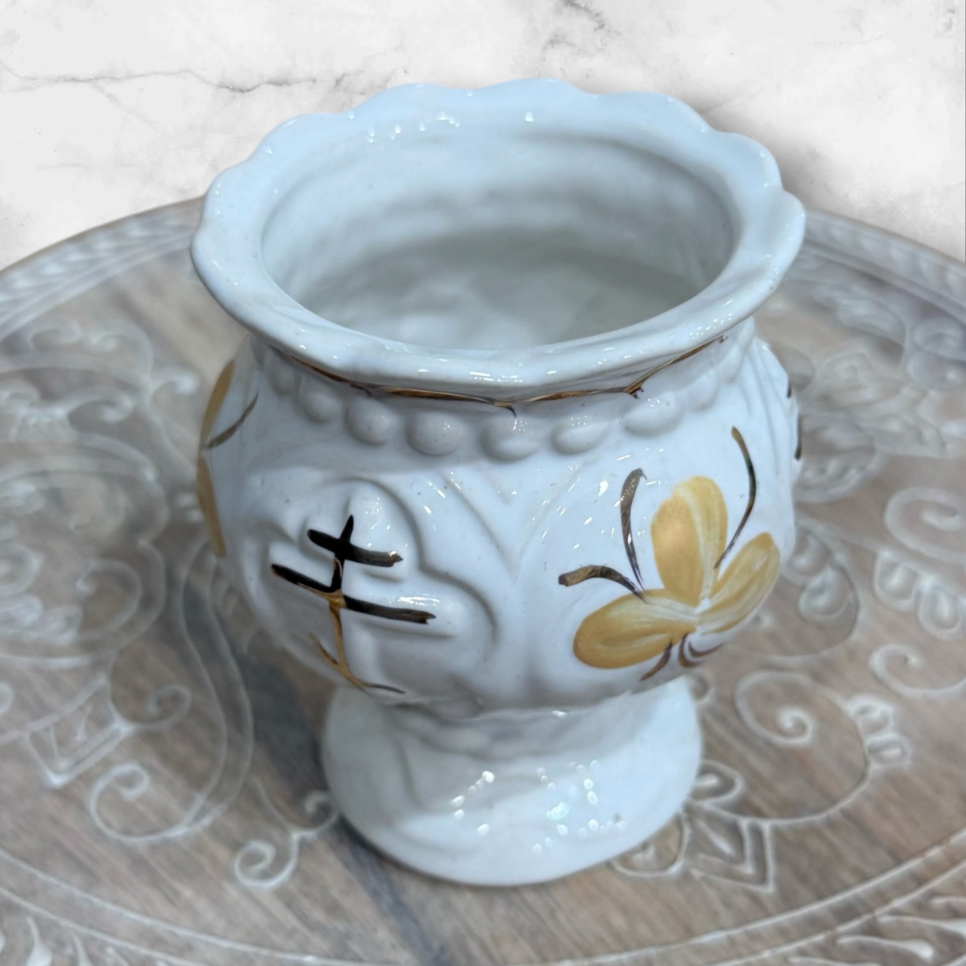 White ceramic Orthodox holy water cup with gold cross and floral decoration on a pedestal base