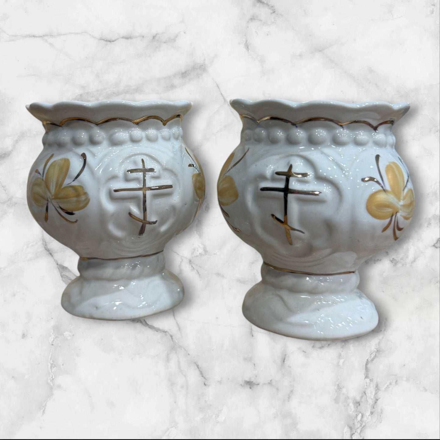 set of White ceramic Orthodox holy water cup with gold cross and floral decoration on a pedestal base