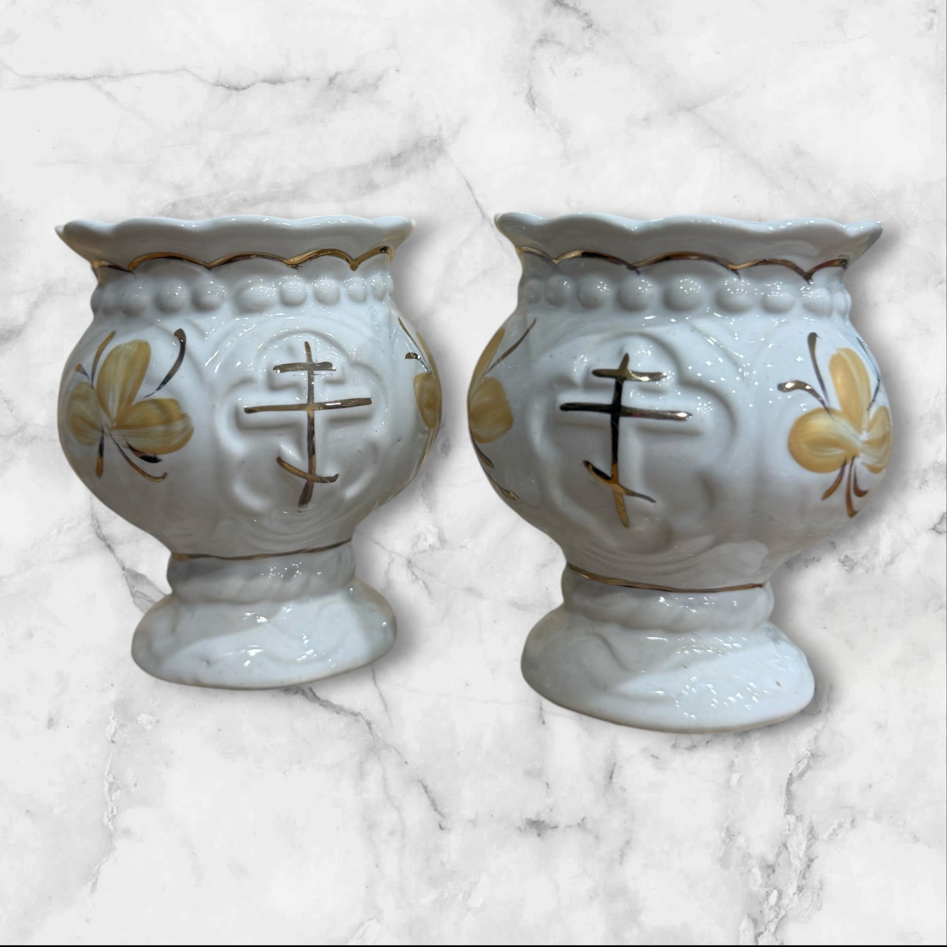 set of White ceramic Orthodox holy water cup with gold cross and floral decoration on a pedestal base