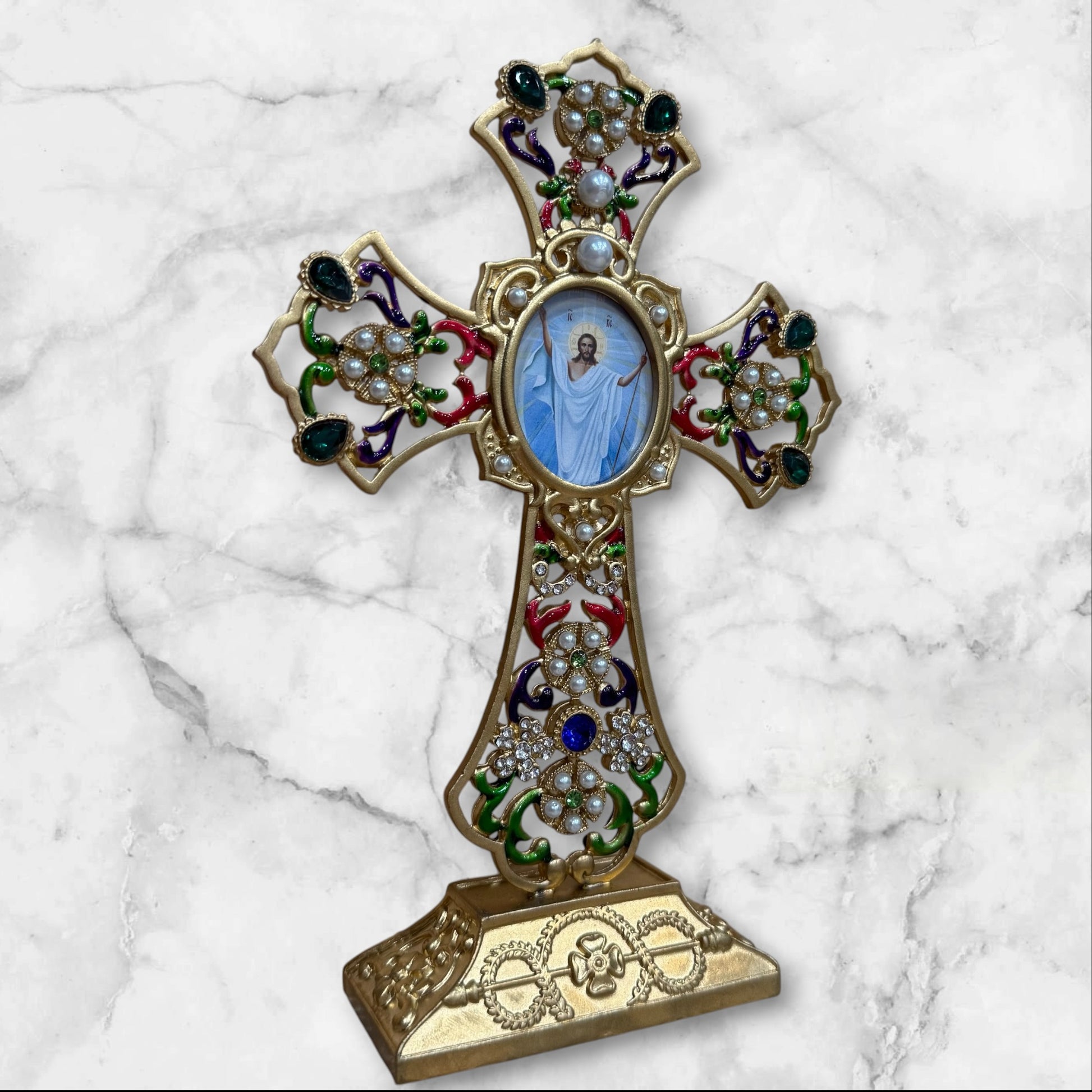 Decorative Orthodox cross-shaped icon stand with colorful enamel accents and a removable oval icon for a home prayer corner angled front view