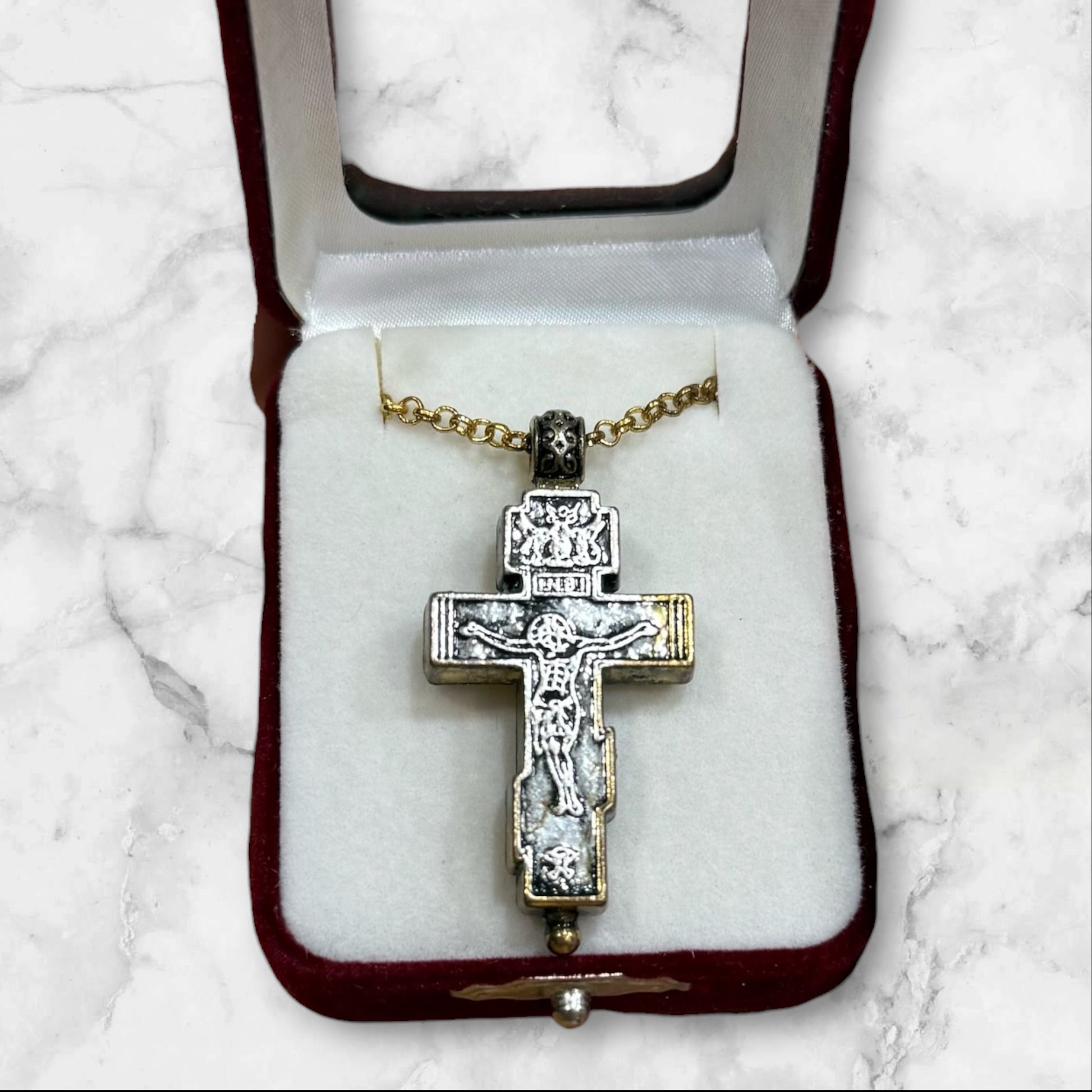 Orthodox two-tone crucifix pendant with double-sided iconography displayed in a velvet gift box
