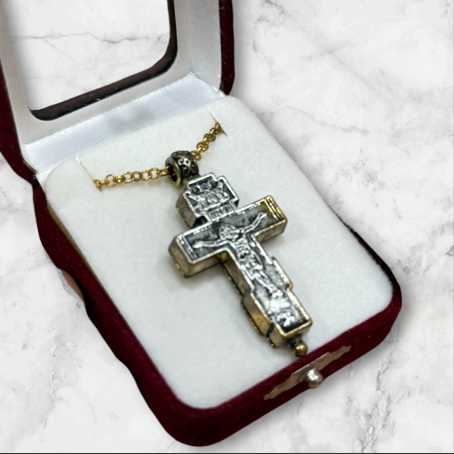 Orthodox two-tone crucifix pendant with double-sided iconography displayed in a velvet gift box