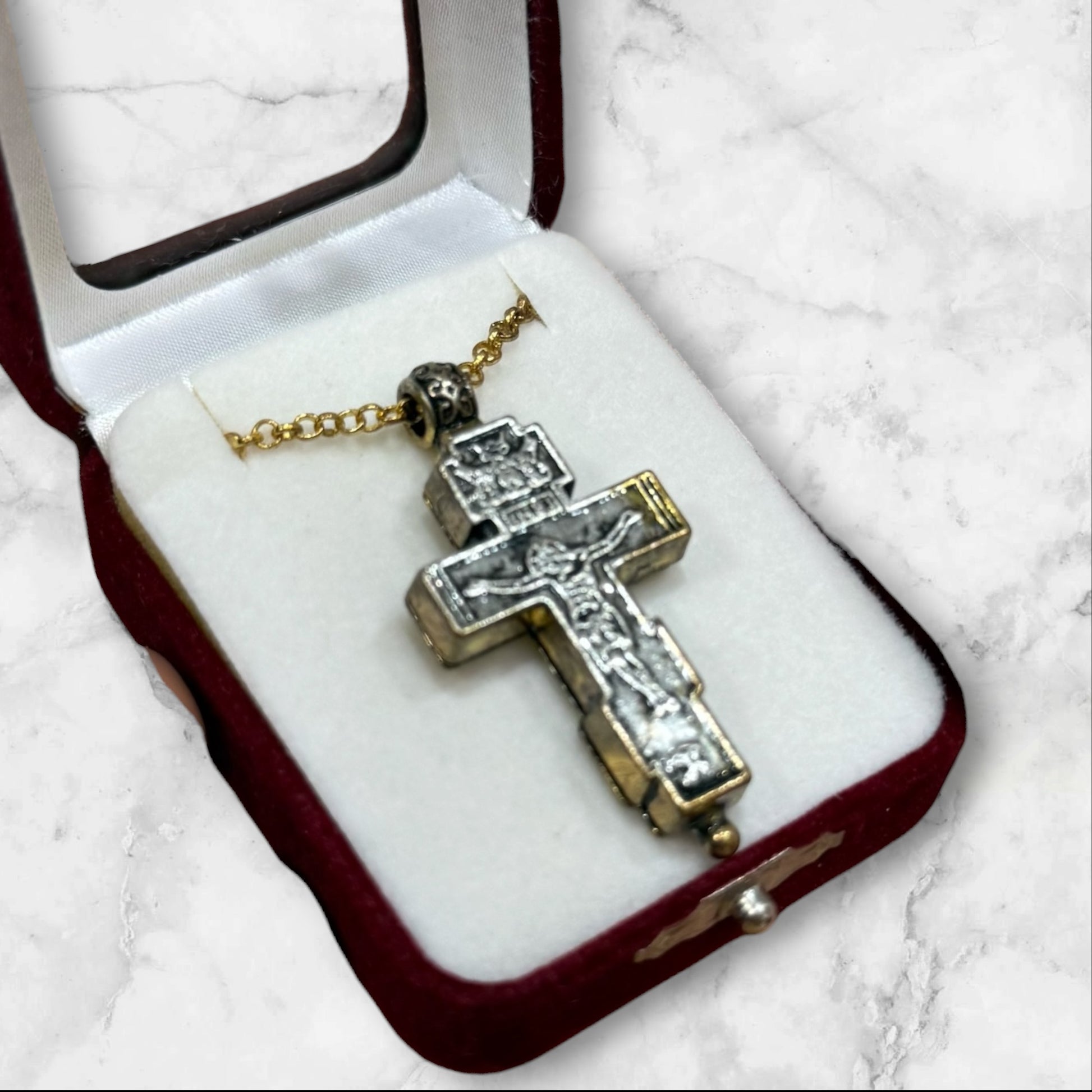 Orthodox two-tone crucifix pendant with double-sided iconography displayed in a velvet gift box
