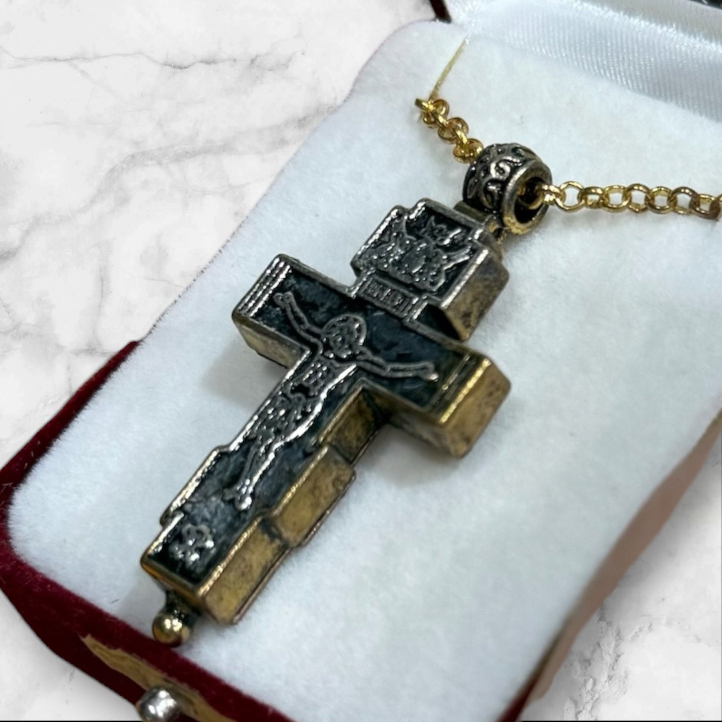 Orthodox two-tone crucifix pendant with double-sided iconography displayed in a velvet gift box back side