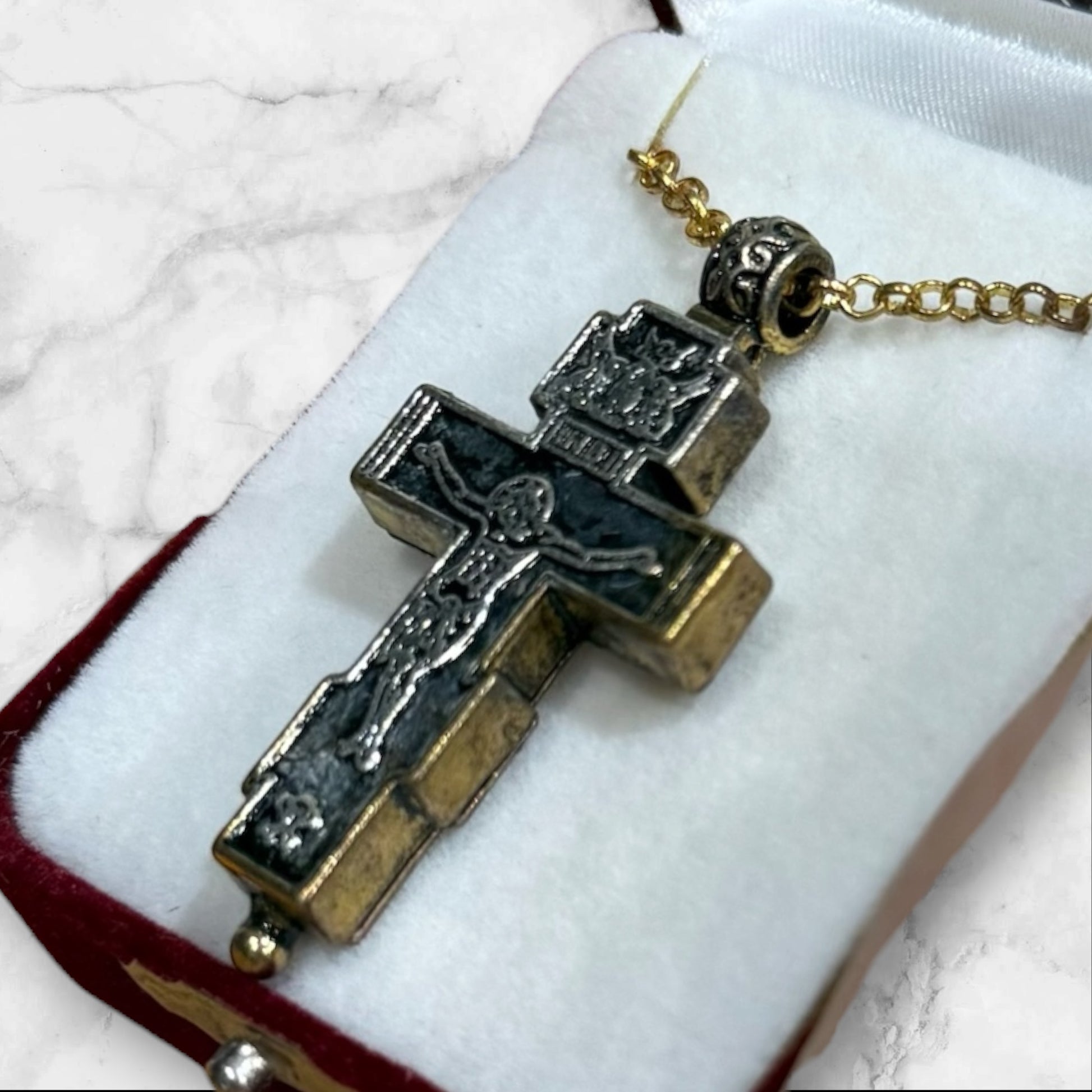 Orthodox two-tone crucifix pendant with double-sided iconography displayed in a velvet gift box back side