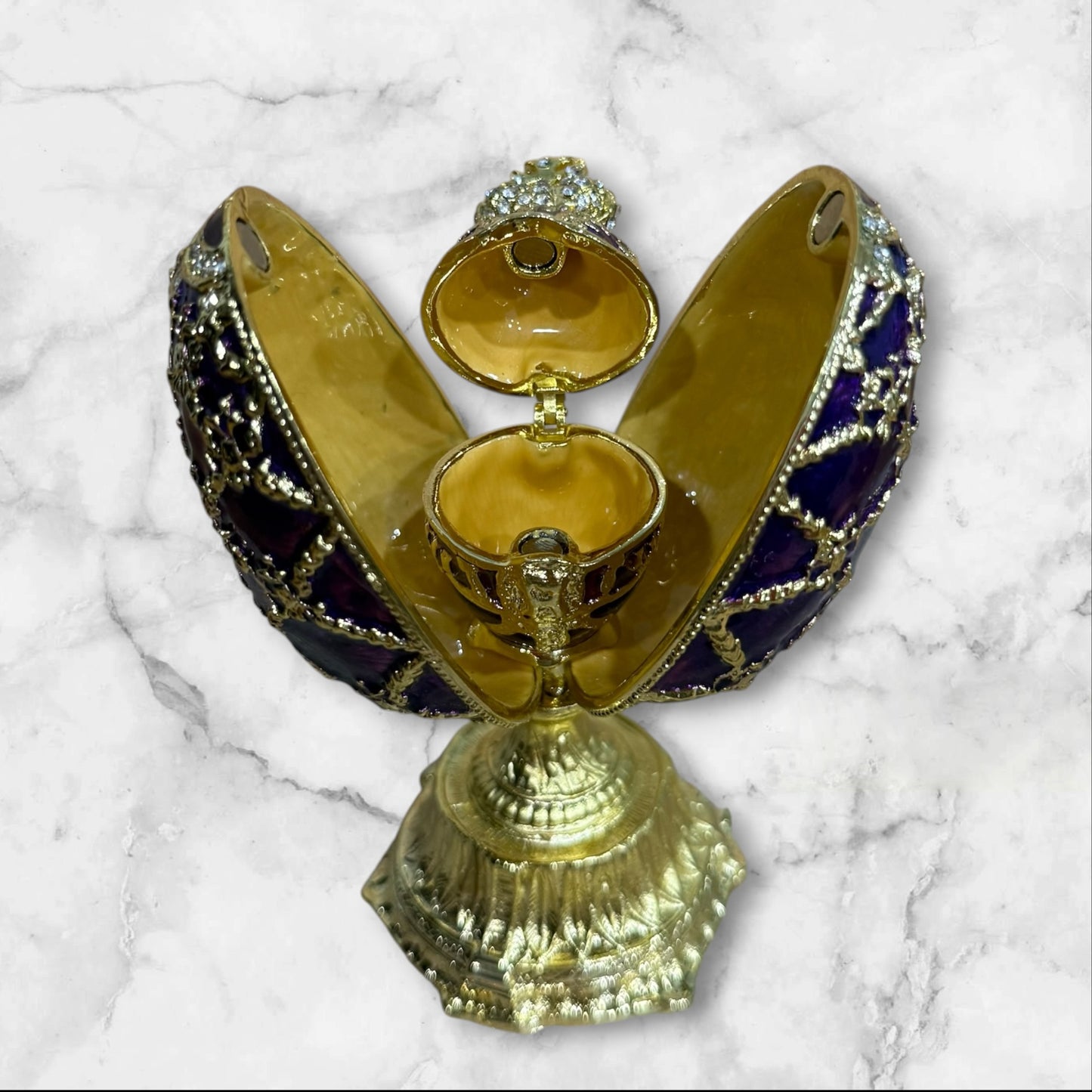 Purple Imperial Fabergé-style egg jewelry box opened to reveal hidden compartment