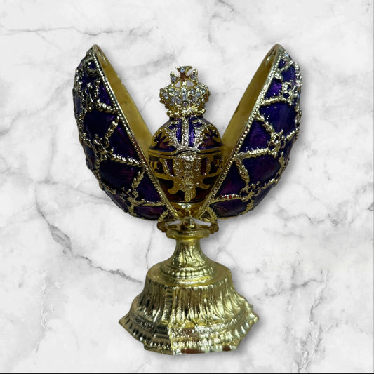 Purple Imperial Fabergé-style egg jewelry box opened to reveal hidden compartment