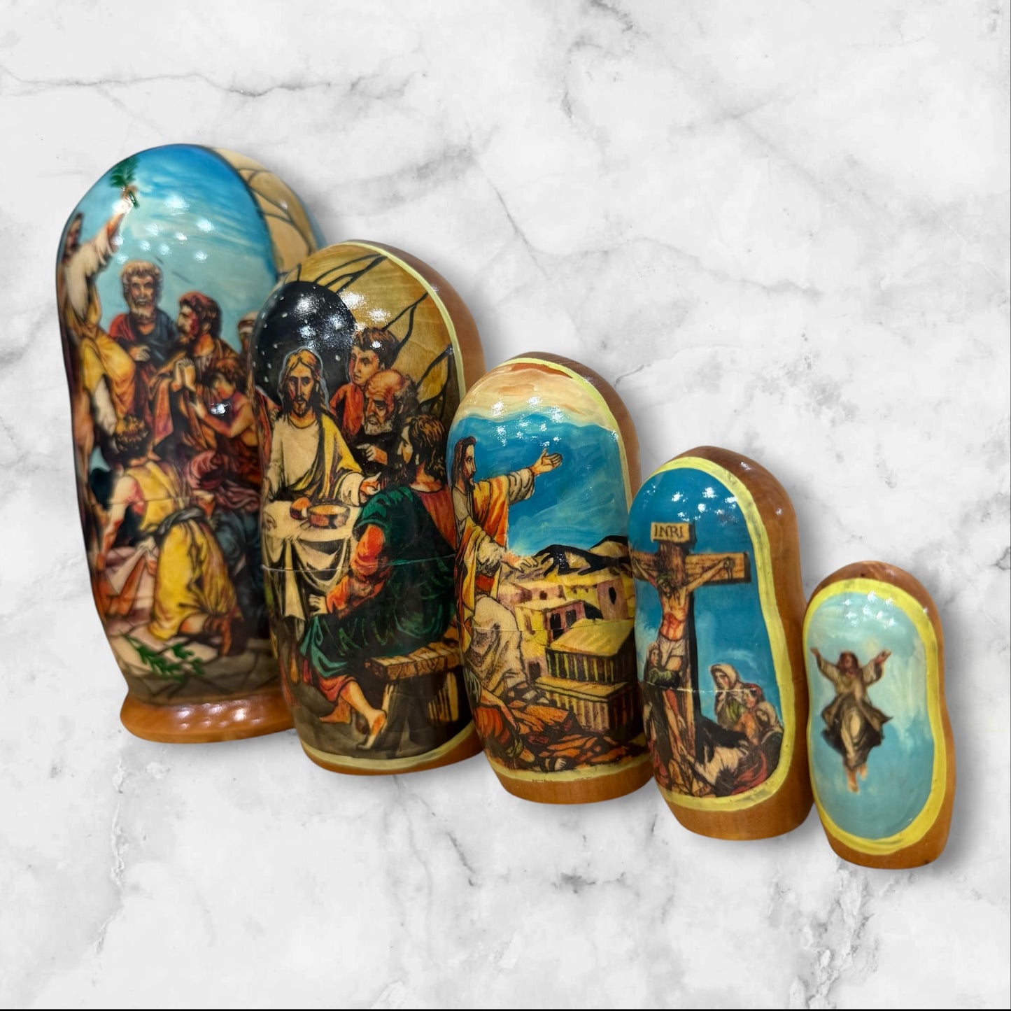 Hand-painted Russian nesting dolls from Sergiev Posad featuring five nesting dolls depicting scenes from the Passion of Christ.
