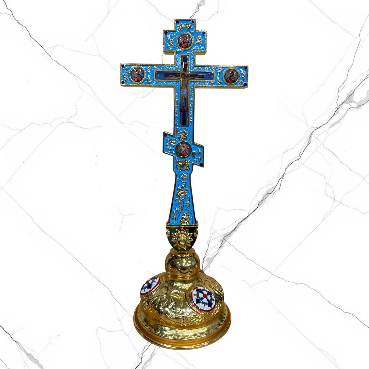 Ornate Orthodox standing blessing cross in blue and gold with sacred icon medallions, jeweled accents, Crucifixion detail, and decorative base.