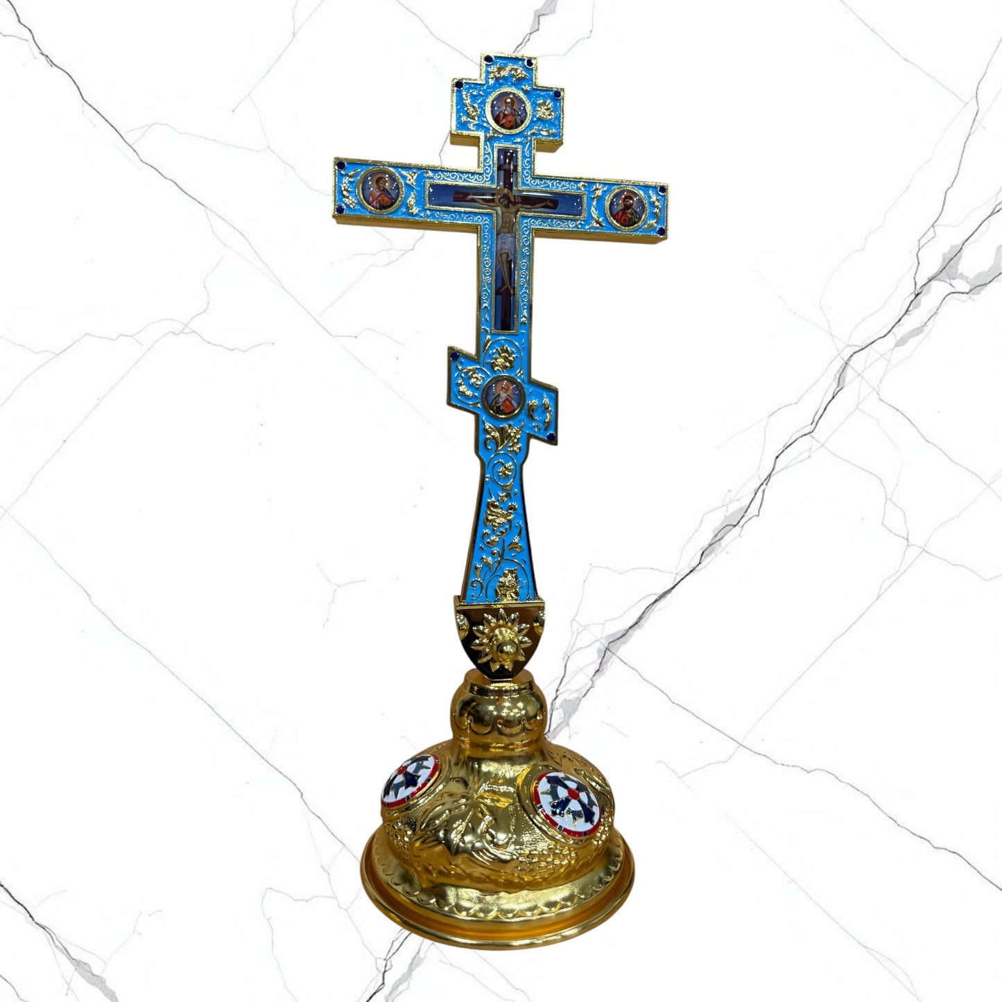 Ornate Orthodox standing blessing cross in blue and gold with sacred icon medallions, jeweled accents, Crucifixion detail, and decorative base.