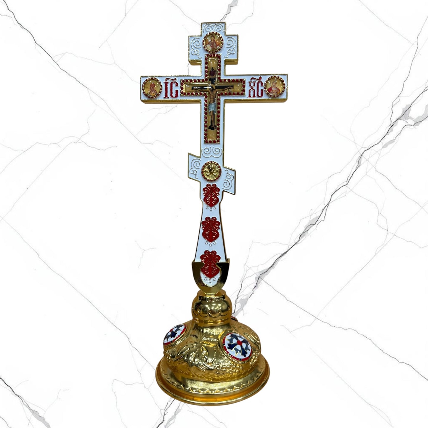 Orthodox standing blessing cross with white and red enamel accents, central crucifix, icon medallions, and decorative gold-tone base.