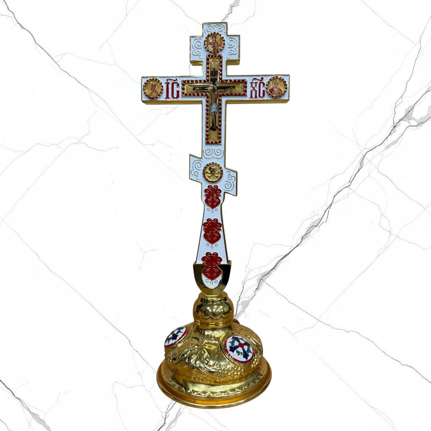 Orthodox standing blessing cross with white and red enamel accents, central crucifix, icon medallions, and decorative gold-tone base.