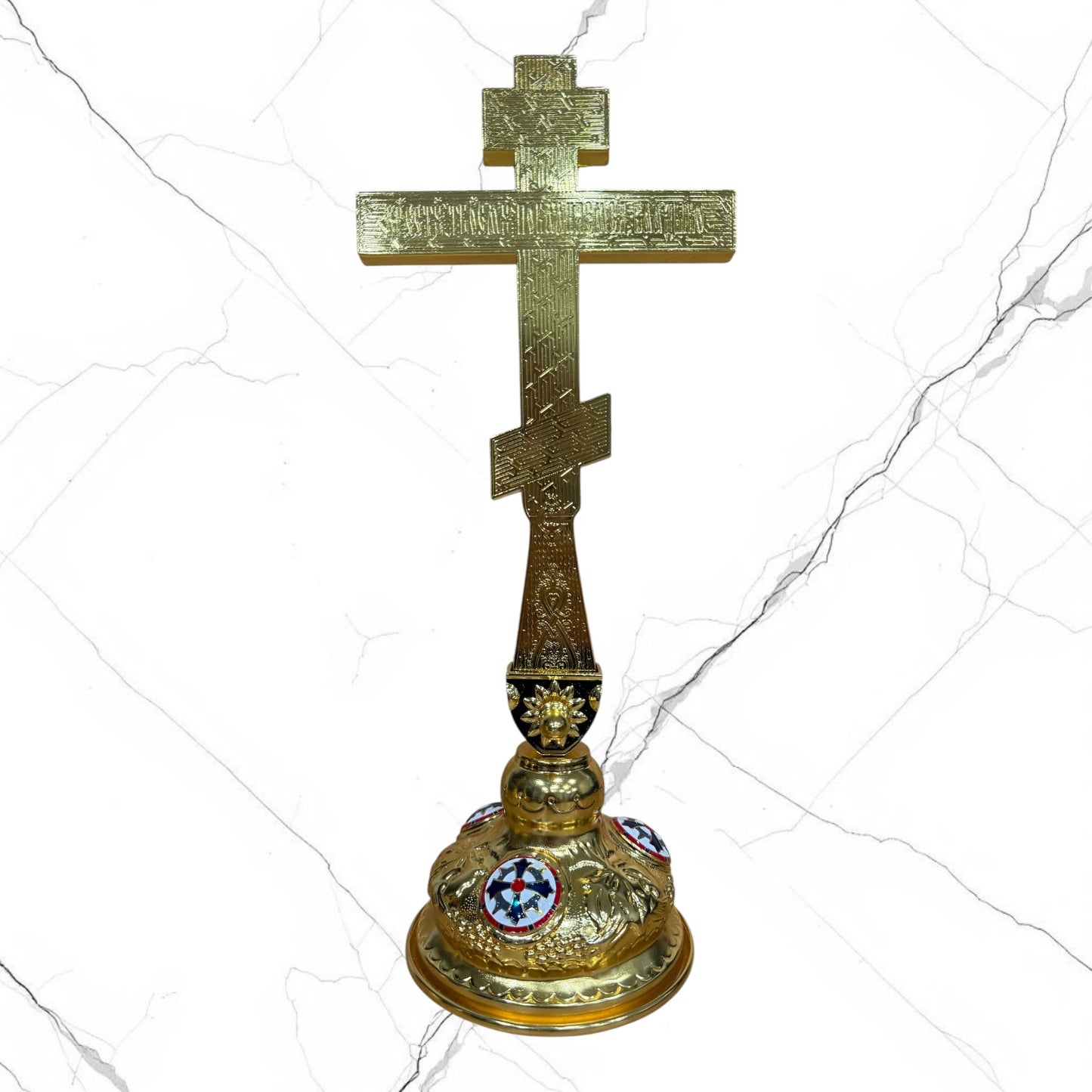 Orthodox standing blessing cross with white and red enamel accents, central crucifix, icon medallions, and decorative gold-tone base.