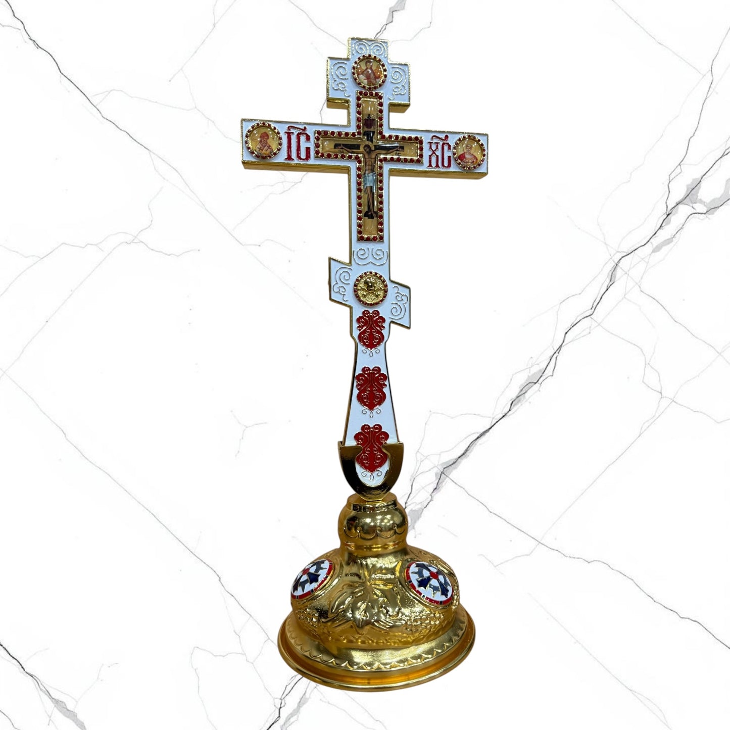 Orthodox standing blessing cross with white and red enamel accents, central crucifix, icon medallions, and decorative gold-tone base.