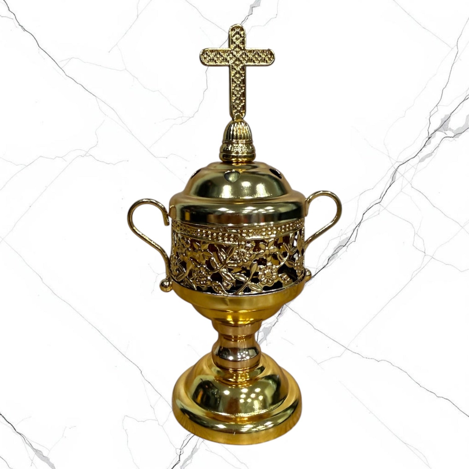 Gold-tone standing incense burner with decorative scroll handles, removable cross lid, charcoal cup, and pedestal base for burning incense during prayer.