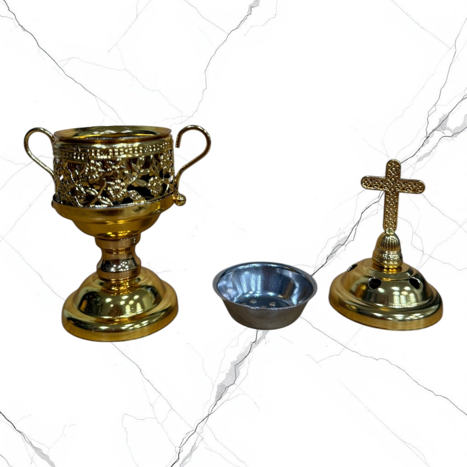 Gold-tone standing incense burner with decorative scroll handles, removable cross lid, charcoal cup, and pedestal base for burning incense during prayer.