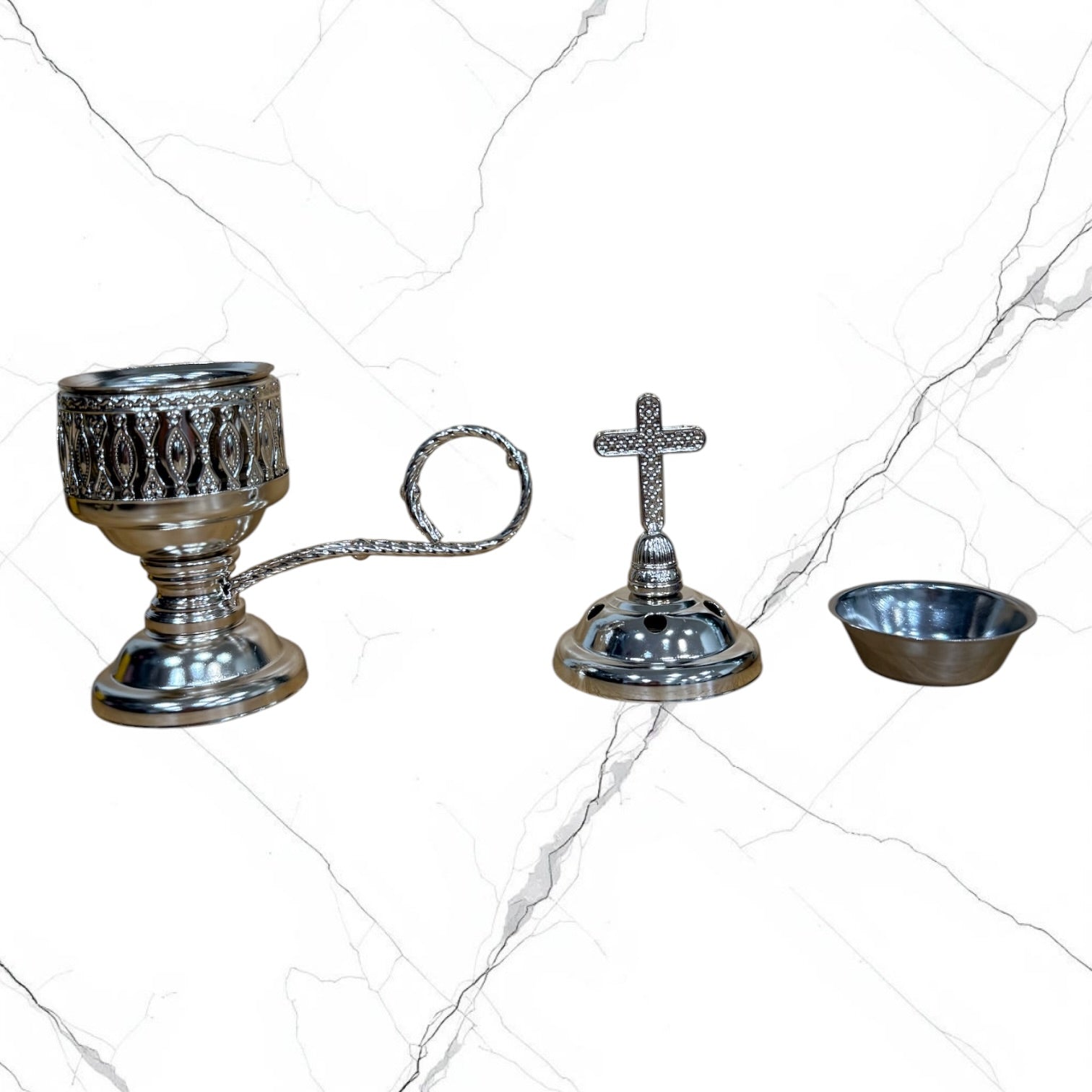 Silver-tone standing incense burner with carrying handle, removable cross lid, charcoal cup, and pedestal base for burning incense during prayer.