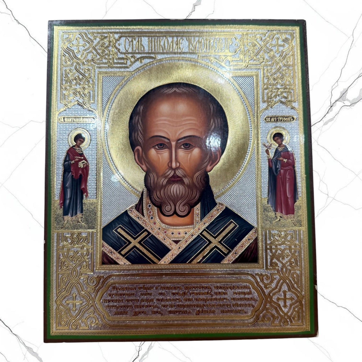 Wood icon of Saint Nicholas the Wonderworker with decorative gold embellishments.